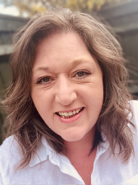 Tory Markham-Beech, member celebrant and co-founder, smiling in her garden